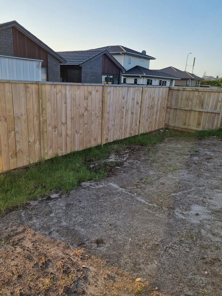 Completed straight timber boundary fence in a residential yard